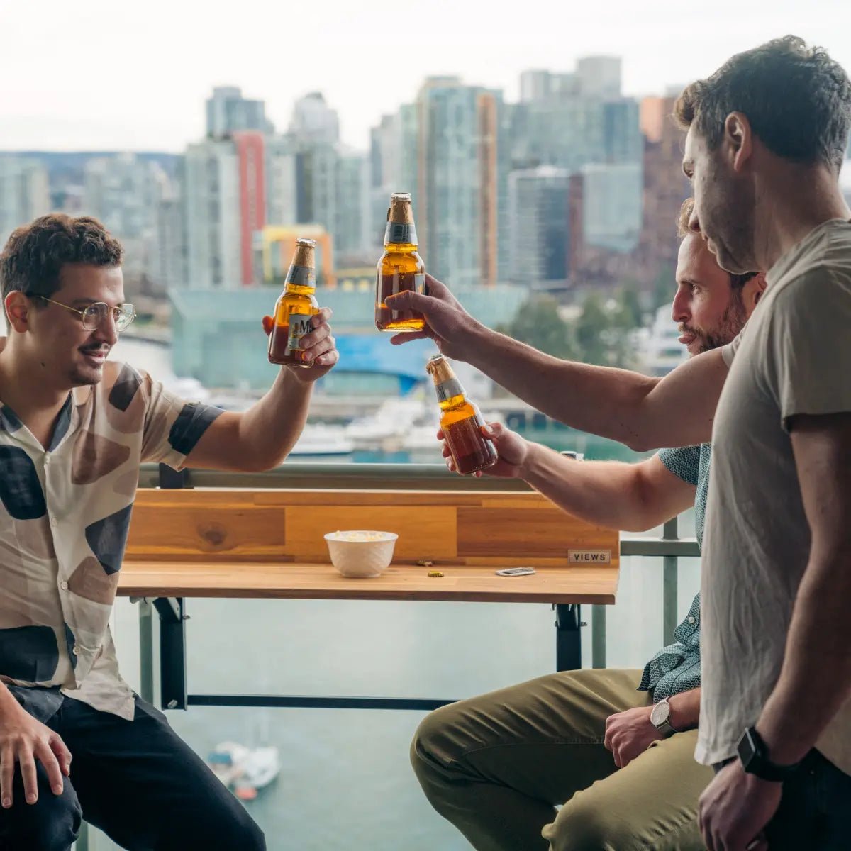 Views Balcony Bar (3Ft) friends enjoying happy hour at a balcony bar table with a city view
